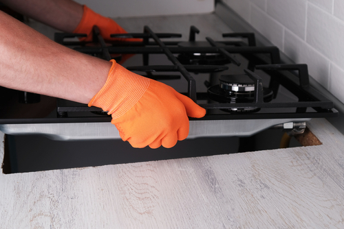 Installing,Gas,Hob,In,Kitchen,Set,,Hands,Of,Master,Close-up